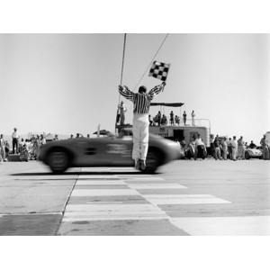 H. Armstrong Roberts - Man jumping waving checkered flag